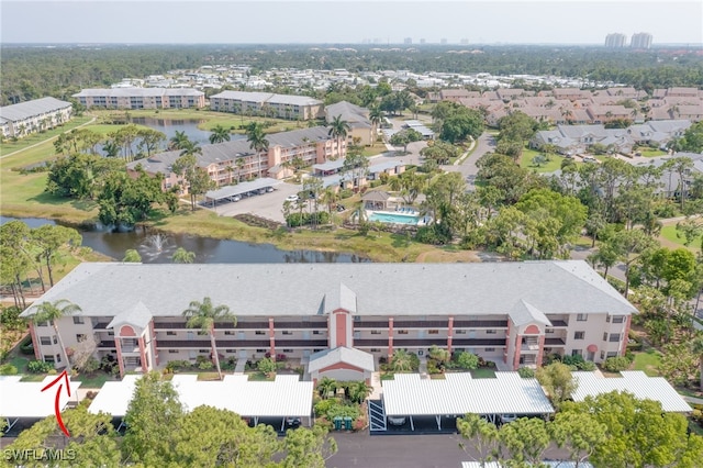 drone / aerial view with a water view and a residential view