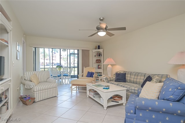 living area with light tile patterned floors and a ceiling fan