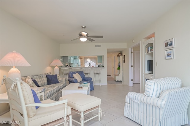 living area featuring ceiling fan, light tile patterned flooring, and visible vents