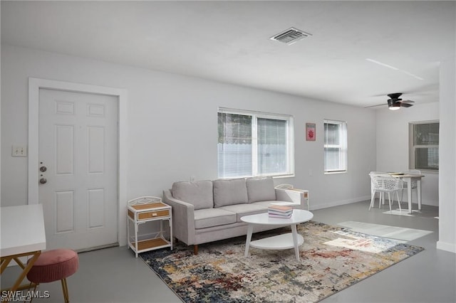 living room featuring a ceiling fan and visible vents