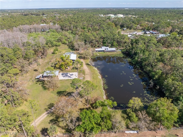 birds eye view of property featuring a water view and a view of trees