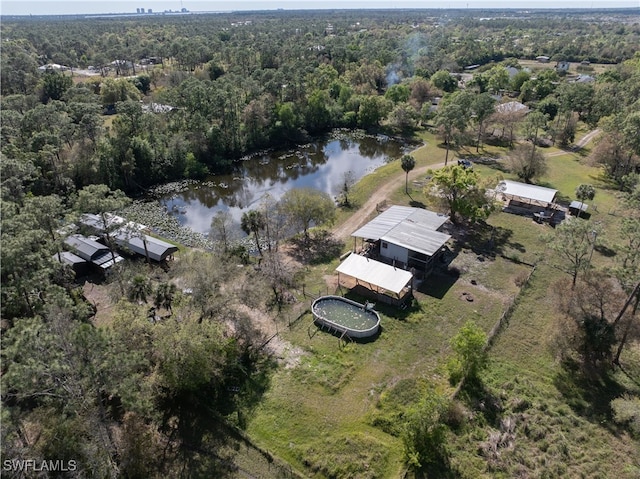 drone / aerial view with a water view and a forest view