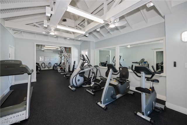 workout area featuring ceiling fan, baseboards, and vaulted ceiling