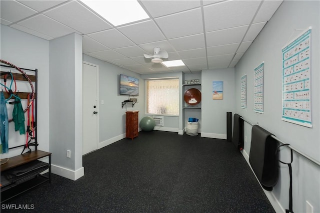 interior space with a drop ceiling and baseboards