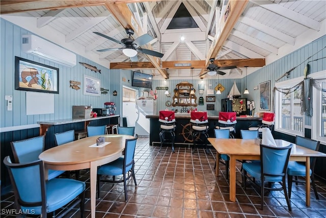 tiled dining space featuring lofted ceiling with beams, ceiling fan, a bar, and a wall mounted AC