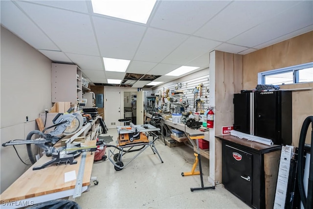 interior space featuring a drop ceiling and a workshop area