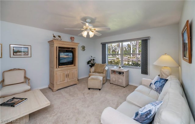 living area with light colored carpet and ceiling fan