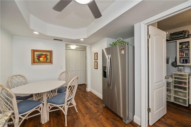 dining room featuring visible vents, ceiling fan, dark wood-type flooring, a tray ceiling, and recessed lighting