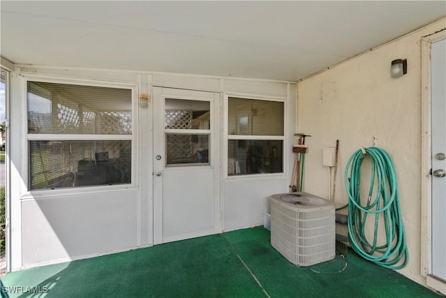 exterior space featuring cooling unit and stucco siding