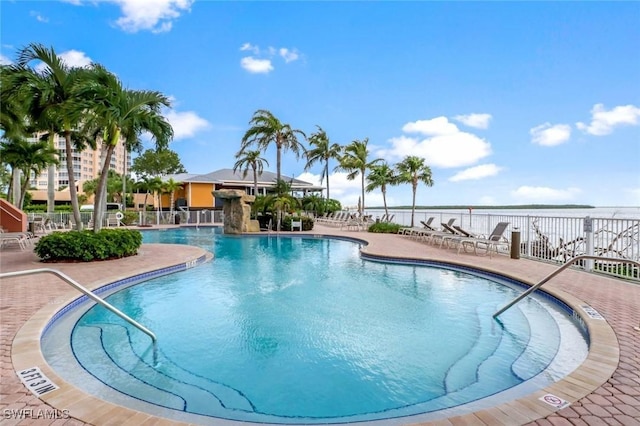 community pool featuring fence and a patio