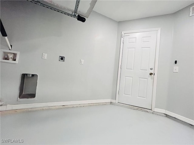 garage featuring baseboards and visible vents