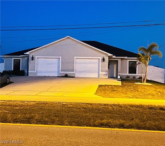 single story home featuring driveway and an attached garage