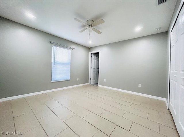 empty room with visible vents, baseboards, a ceiling fan, and light tile patterned flooring