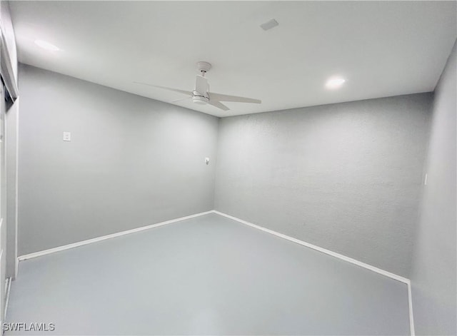 empty room featuring ceiling fan, concrete floors, and baseboards