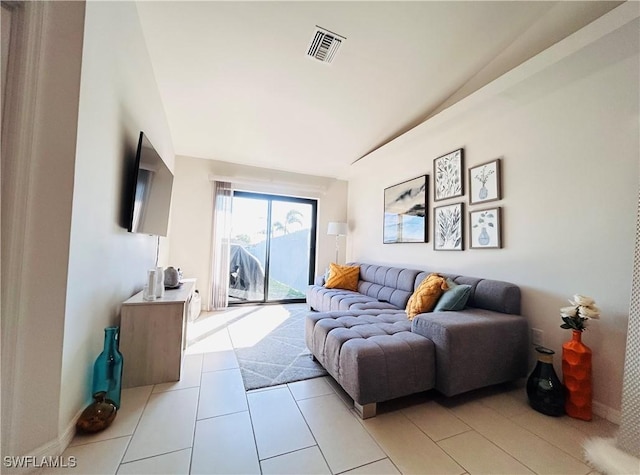 living area featuring light tile patterned flooring and visible vents