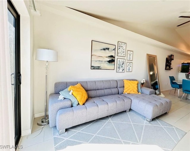 tiled living area with vaulted ceiling and ceiling fan