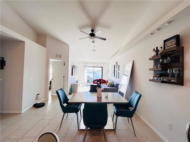 dining area featuring lofted ceiling, a ceiling fan, visible vents, and baseboards