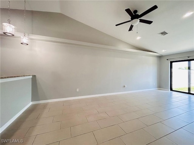 empty room with tile patterned flooring, visible vents, lofted ceiling, and baseboards