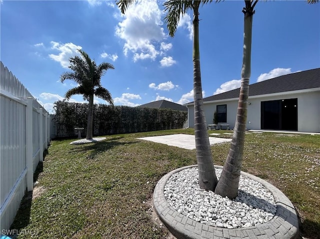 view of yard with a patio area and a fenced backyard