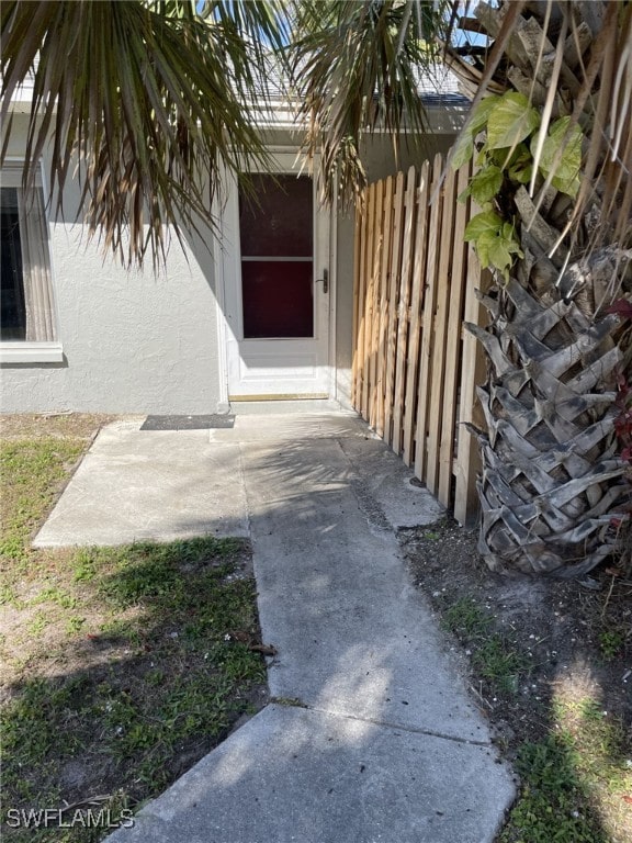 entrance to property with stucco siding