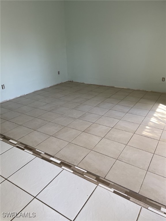 unfurnished room with light tile patterned floors