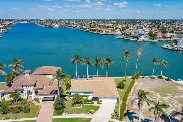 drone / aerial view with a water view and a residential view