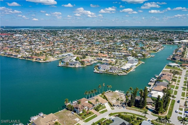 birds eye view of property with a water view and a residential view