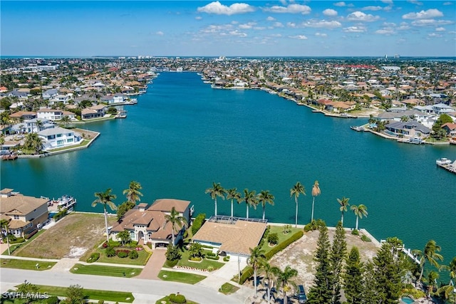 drone / aerial view with a water view and a residential view