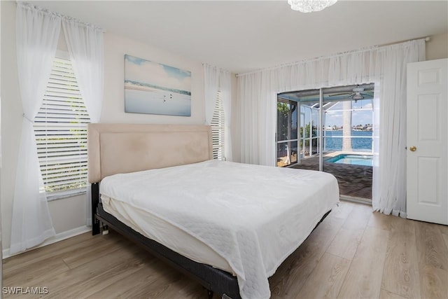 bedroom with access to outside, baseboards, and wood finished floors