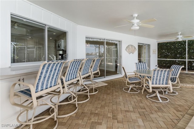 sunroom with a ceiling fan