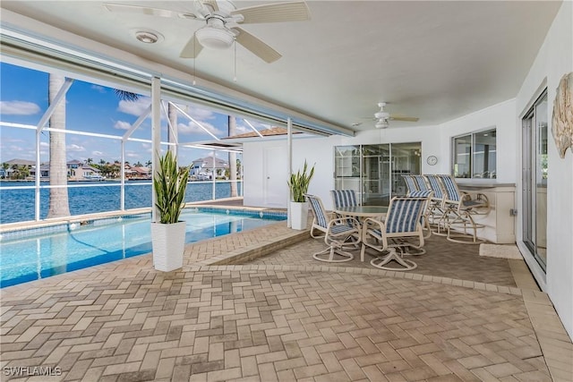 outdoor pool featuring a lanai, ceiling fan, and a patio