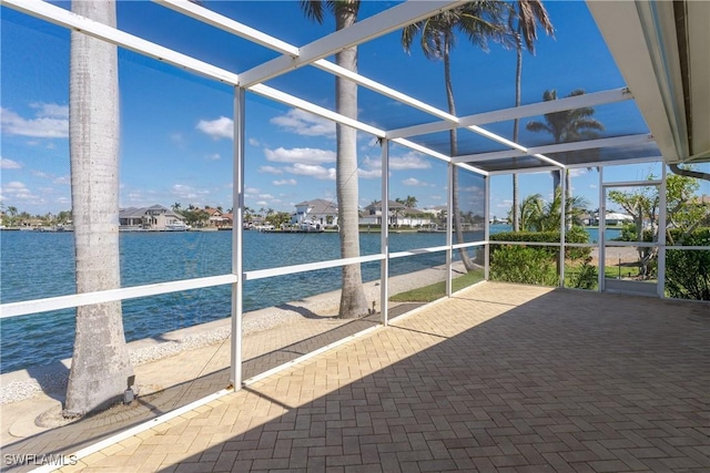 unfurnished sunroom featuring a water view