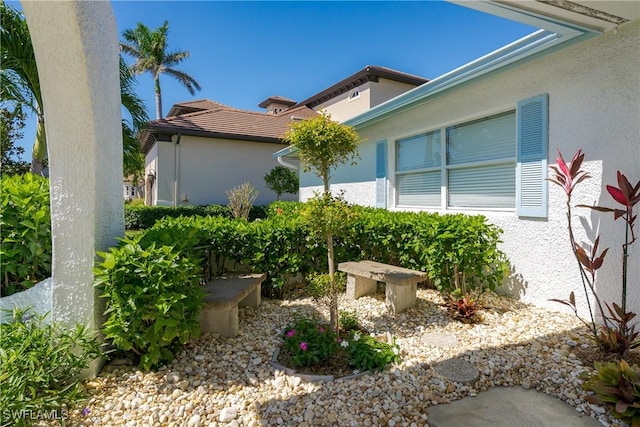 view of home's exterior featuring a tiled roof and stucco siding