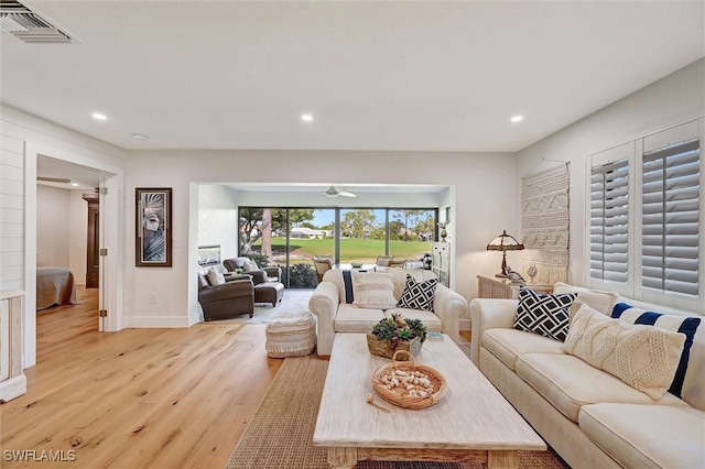 living area featuring recessed lighting, visible vents, and light wood-style flooring