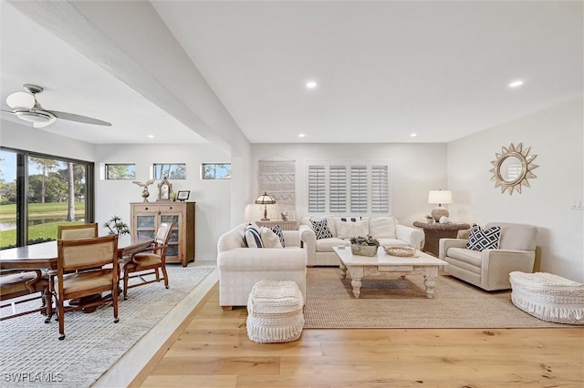 living area with light wood-style floors, ceiling fan, and recessed lighting