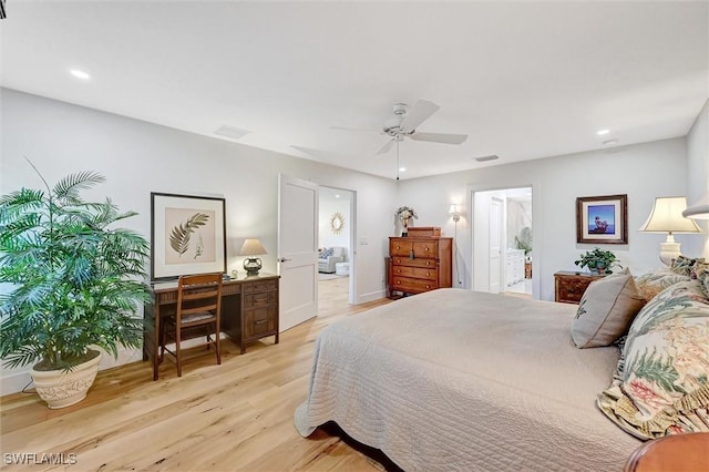 bedroom featuring ceiling fan, light wood finished floors, ensuite bath, and visible vents