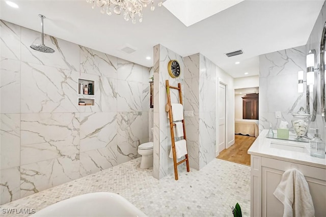 full bath with connected bathroom, toilet, vanity, visible vents, and a marble finish shower