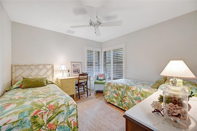 bedroom featuring visible vents, ceiling fan, and light wood-style flooring