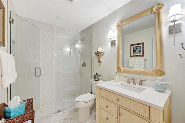 bathroom featuring toilet, a shower stall, and vanity