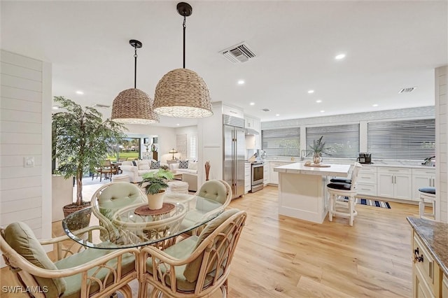 dining room with recessed lighting, visible vents, and light wood finished floors