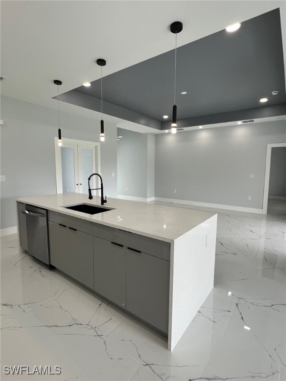 kitchen with dishwasher, hanging light fixtures, a sink, and a large island with sink