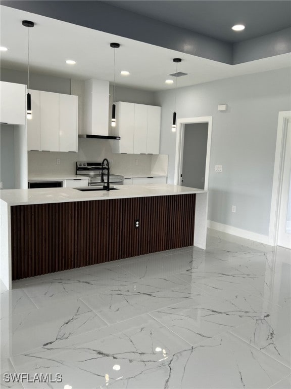 kitchen featuring light countertops, modern cabinets, white cabinetry, and pendant lighting