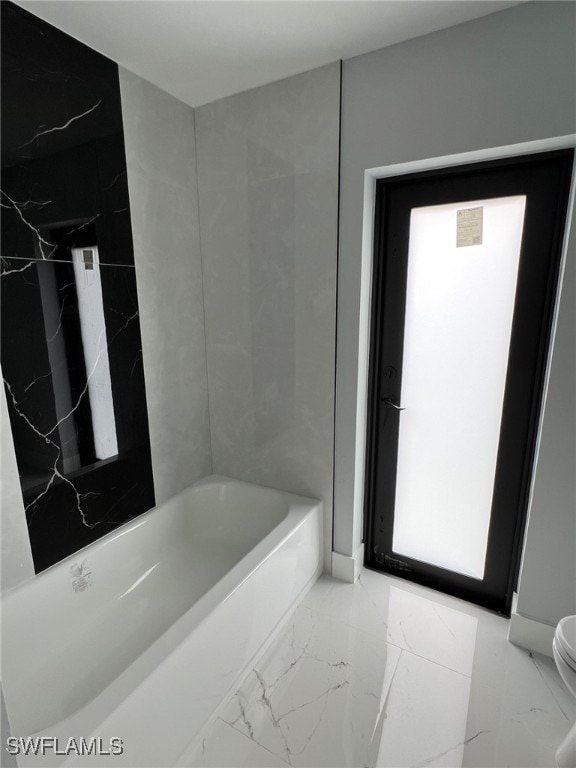 full bathroom with marble finish floor and toilet