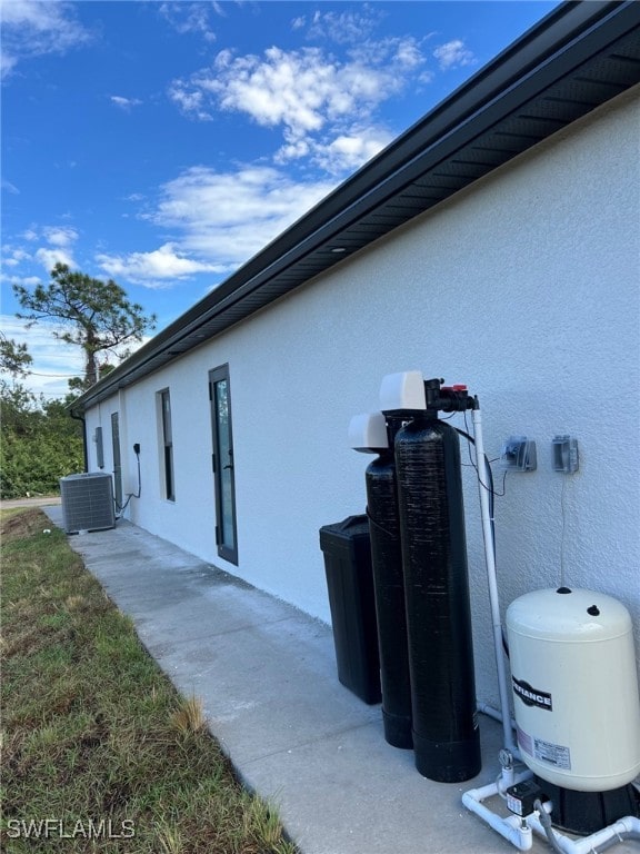 view of home's exterior with central AC unit and stucco siding