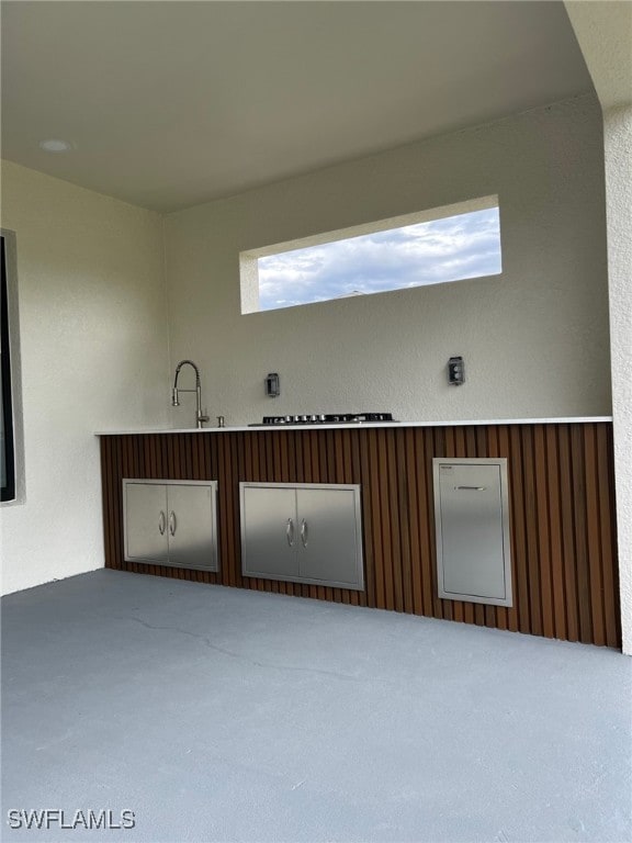 spare room with a textured wall and a sink