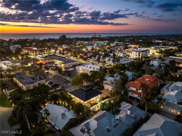 aerial view at dusk with a water view