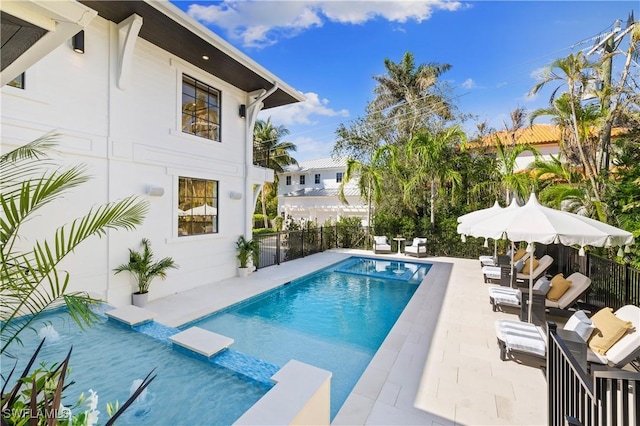 view of pool featuring a patio area, a fenced backyard, and a fenced in pool