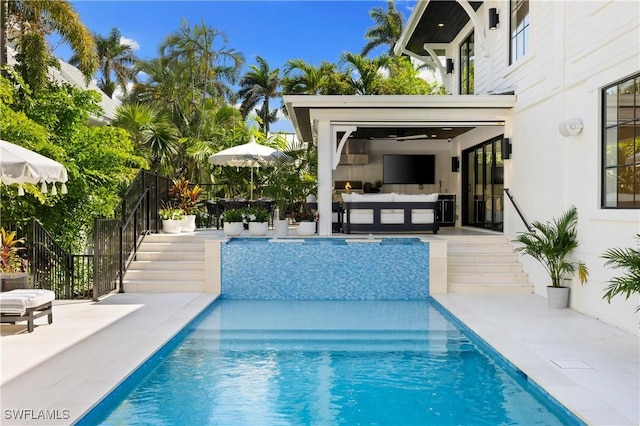 view of swimming pool featuring an outdoor hangout area, a patio, stairs, and a fenced in pool