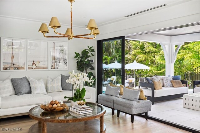 living room featuring a chandelier, wood finished floors, and visible vents