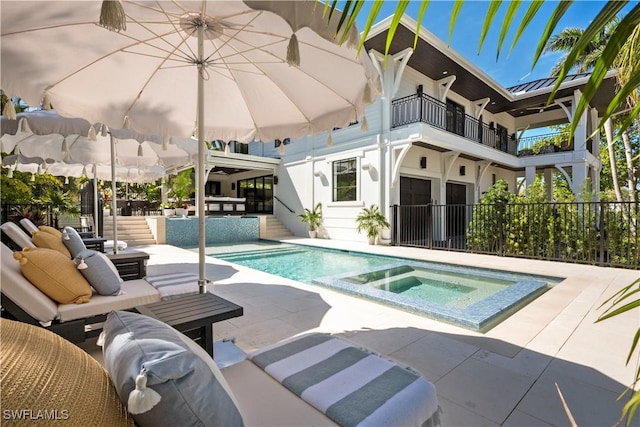 view of swimming pool with a fenced in pool, a patio, fence, an in ground hot tub, and an outdoor living space